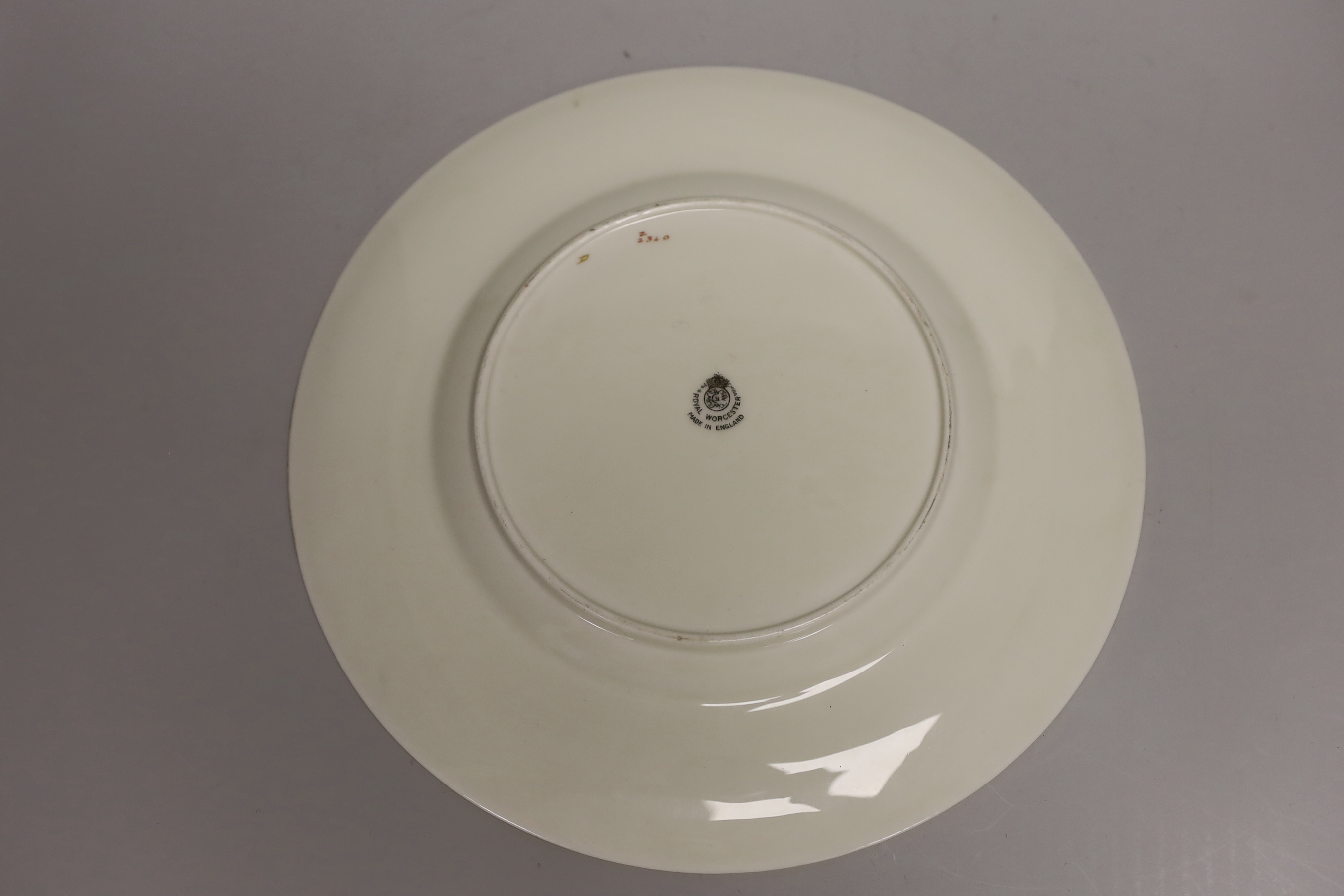 A Royal Worcester fine plate painted with a figure in a tree line landscape by G. Evans, signed and Royal Worcester plates by M Tague, signed with a Bullfinch and a Gold Finch